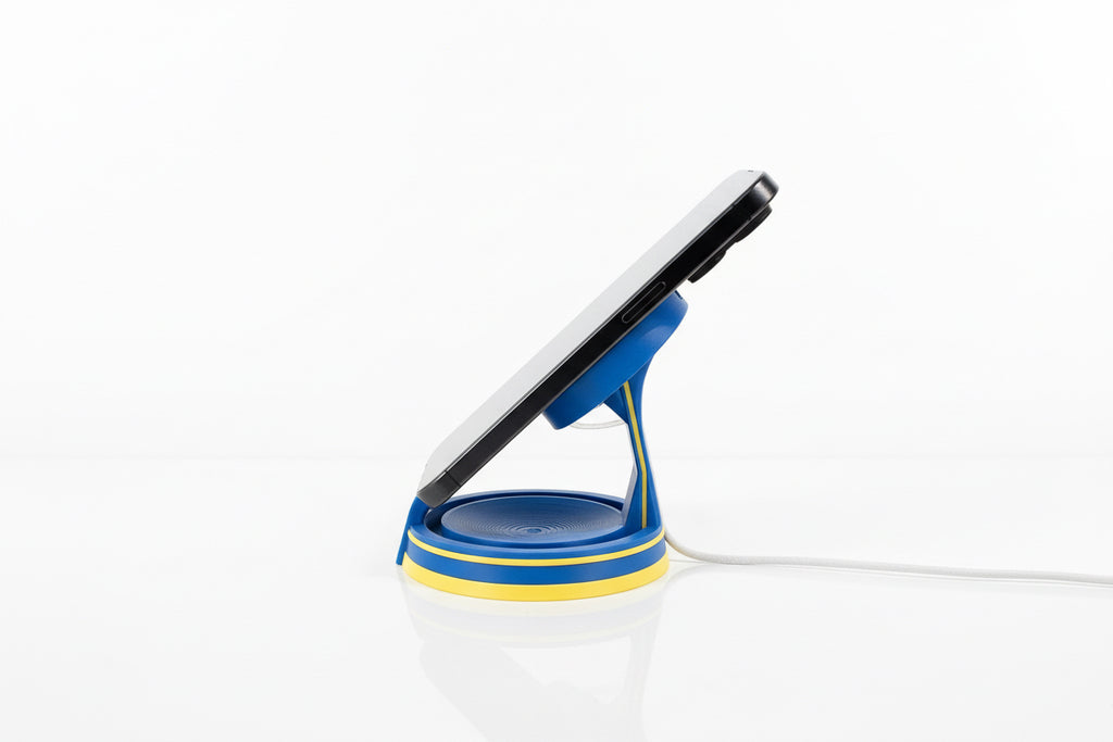 Blue phone fallout inspired stand with a smartphone on a gray surface