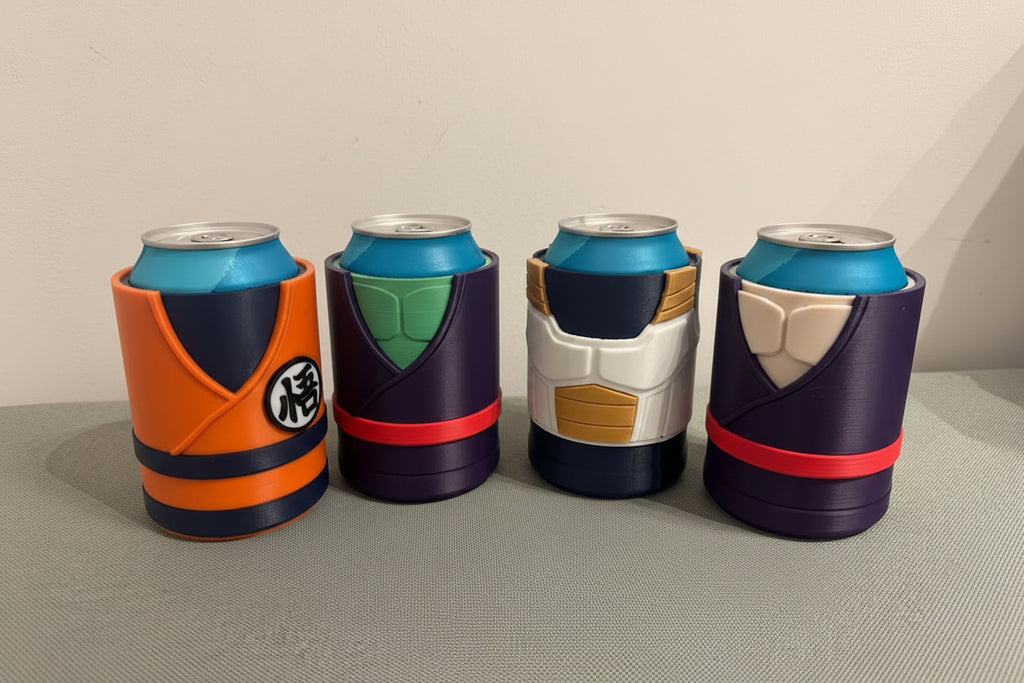 Four colorful can coolers shaped like DBZ costumes on a gray surface.