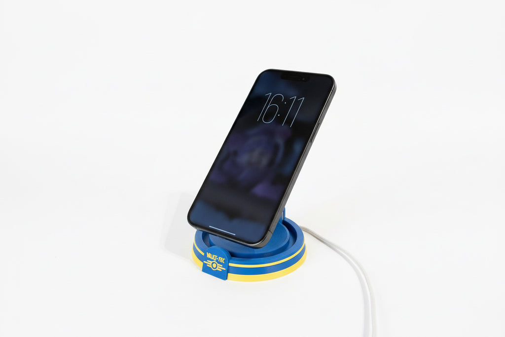 Phone on a blue and yellow fallout inspired charging stand with a white background
