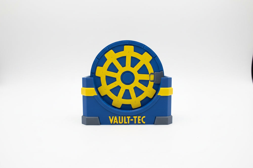 Blue and yellow coaster holder with 'VAULT-TEC' branding on a beige background