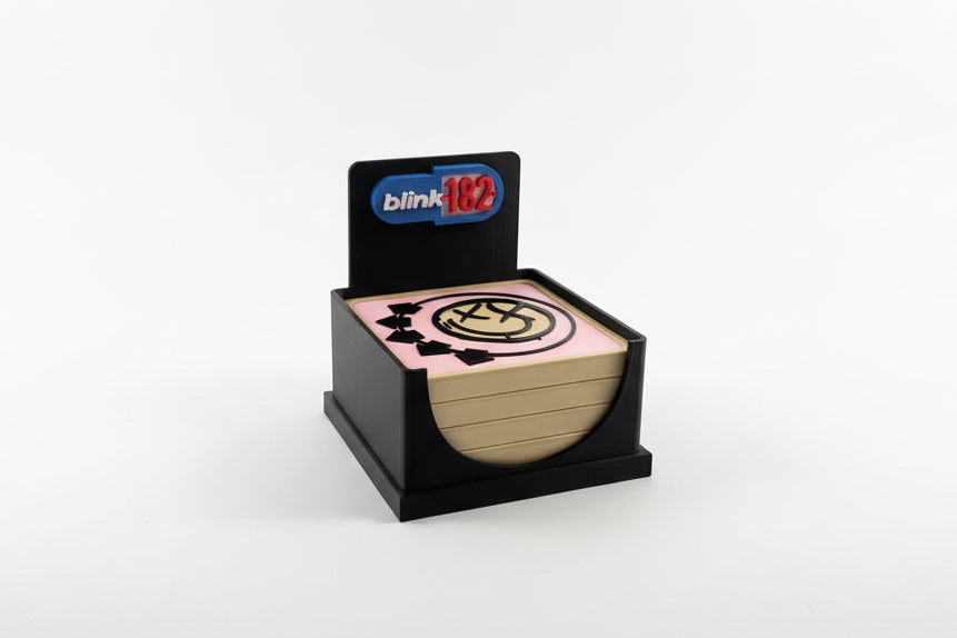 Stack of paper with a logo on top, featuring the 'blink 182' brand.